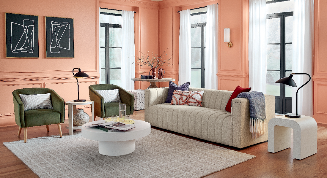 Wide view of living room with soft Persimmon walls, neutral carpet and sofa.